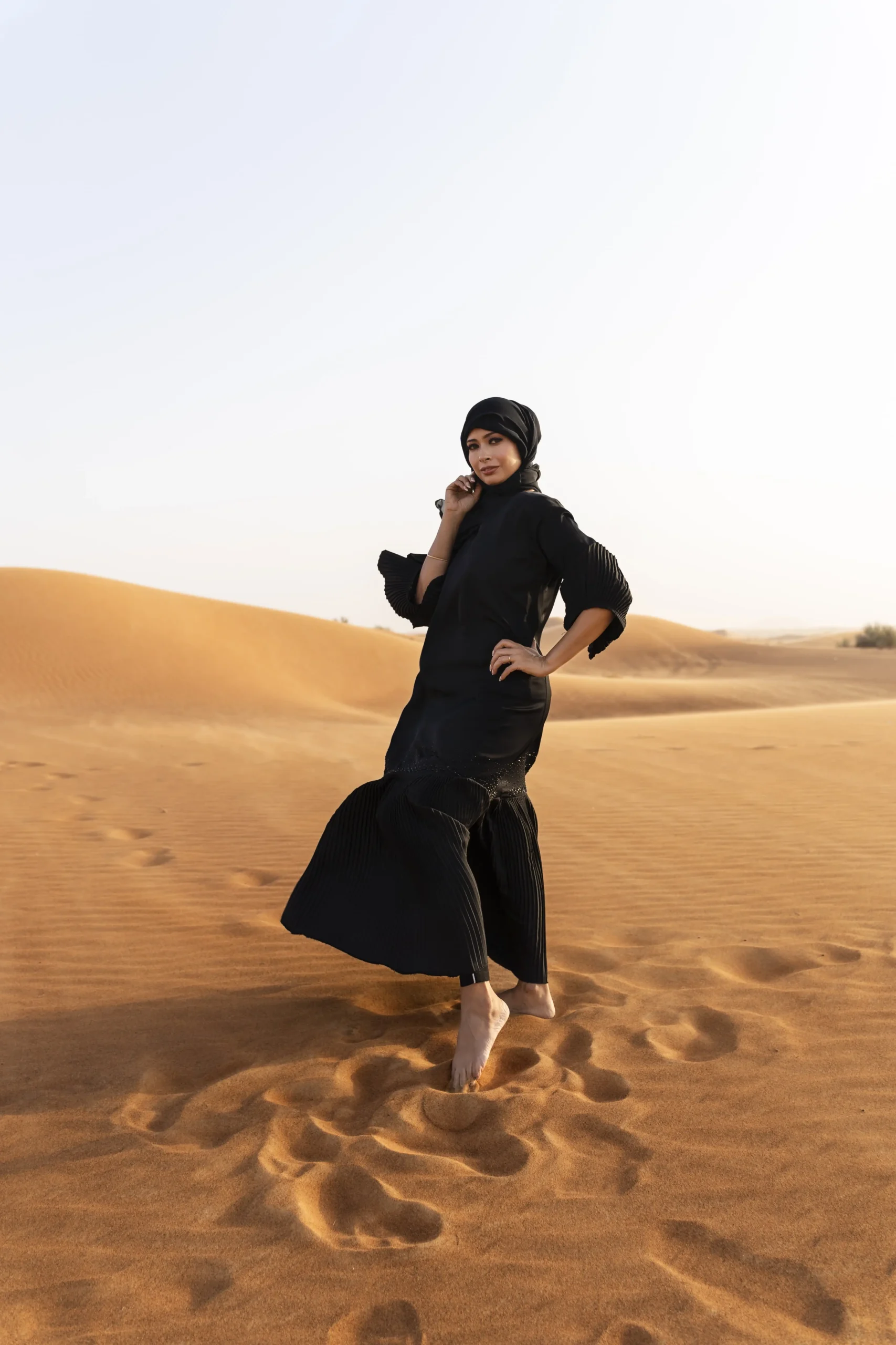4x4 vehicle driving across Abu Dhabi desert dunes