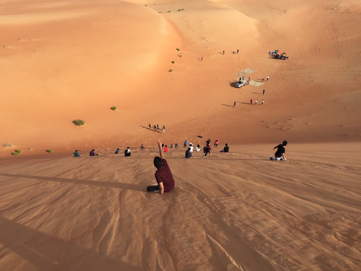 Desert safari guests enjoying the open golden dunes